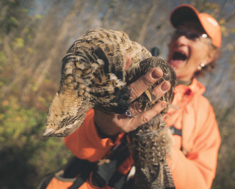 Maine bird hunter Patti Carter with her two German shorthaired pointers
