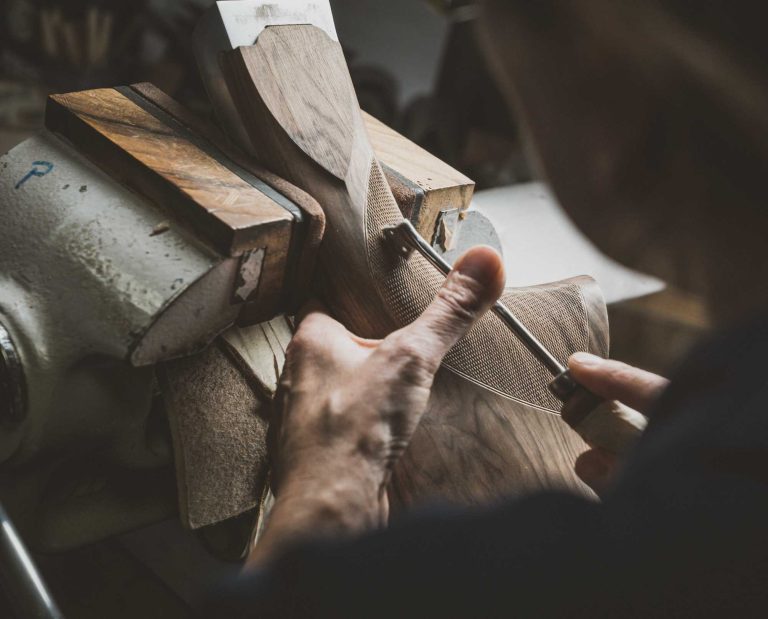 A worker engraving the stock of Beretta SL3 in the factory in Italy.