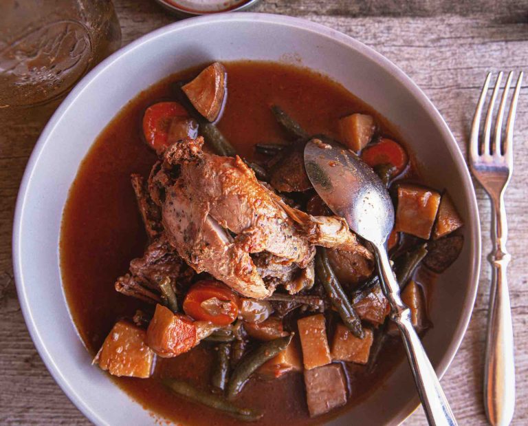Canned quail stew in a bowl with a spoon
