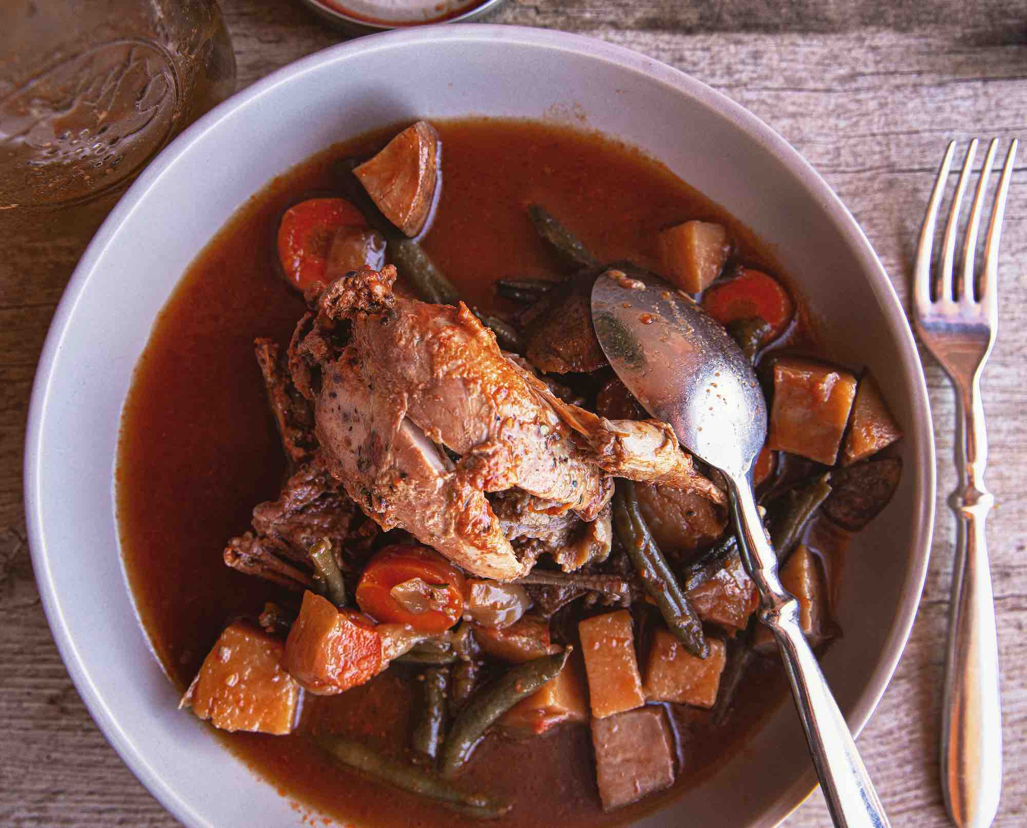 Canned quail stew in a bowl with a spoon