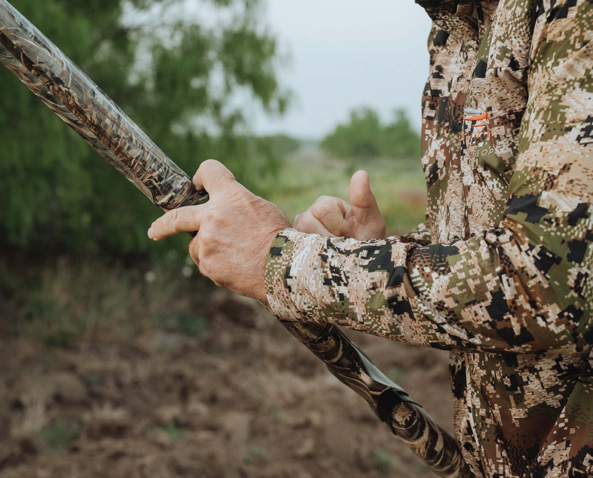 a dove hunter loads a shotgun before the hunt