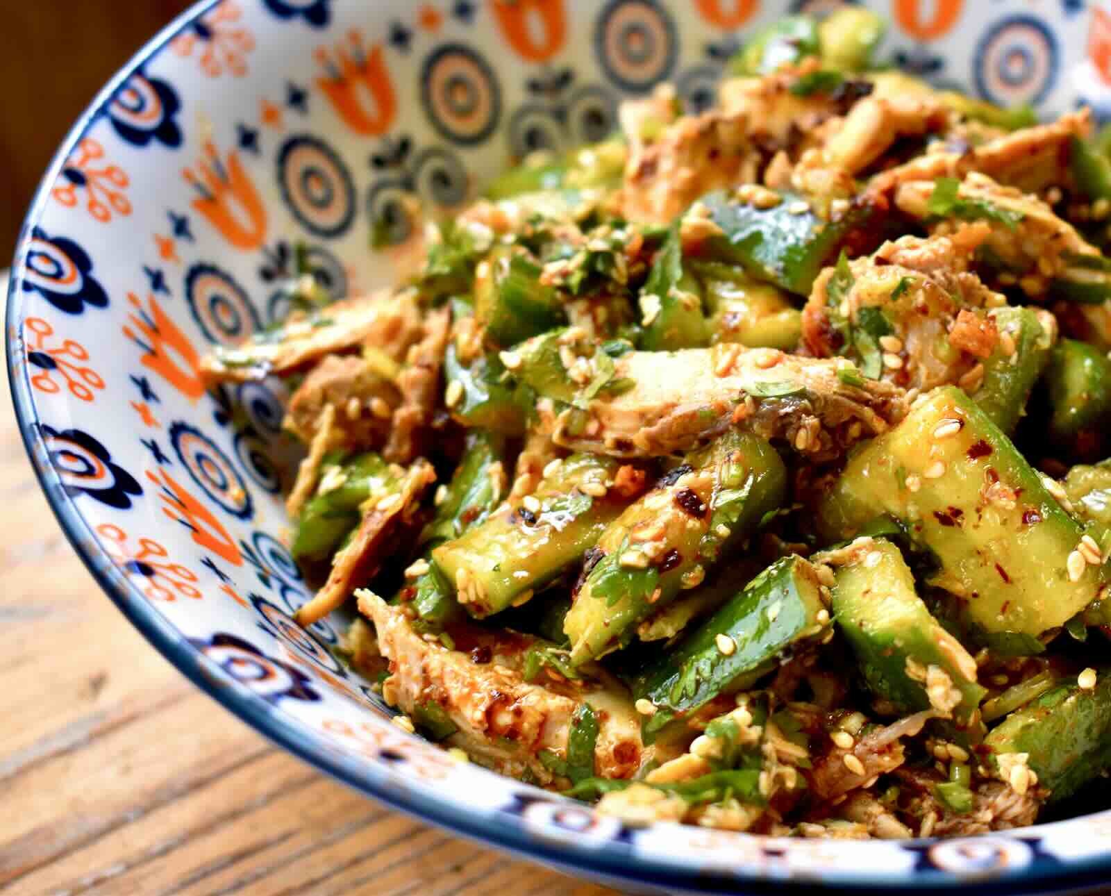 Shredded grouse meat and smacked cucumbers are tossed with an Asian sesame dressing and served in a colorful bowl