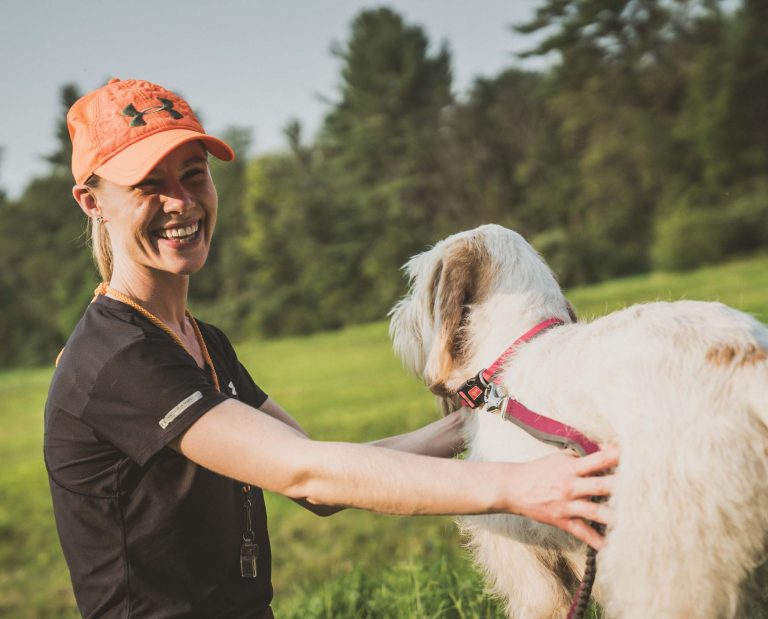 a women handles a bird dog