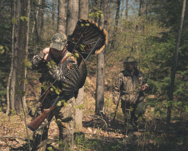 Turkey hunters in the spring woods after shooting a turkey