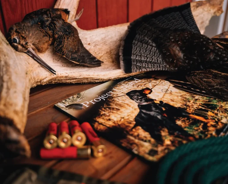An issue of project upland magazine with some upland hunting gear and grouse