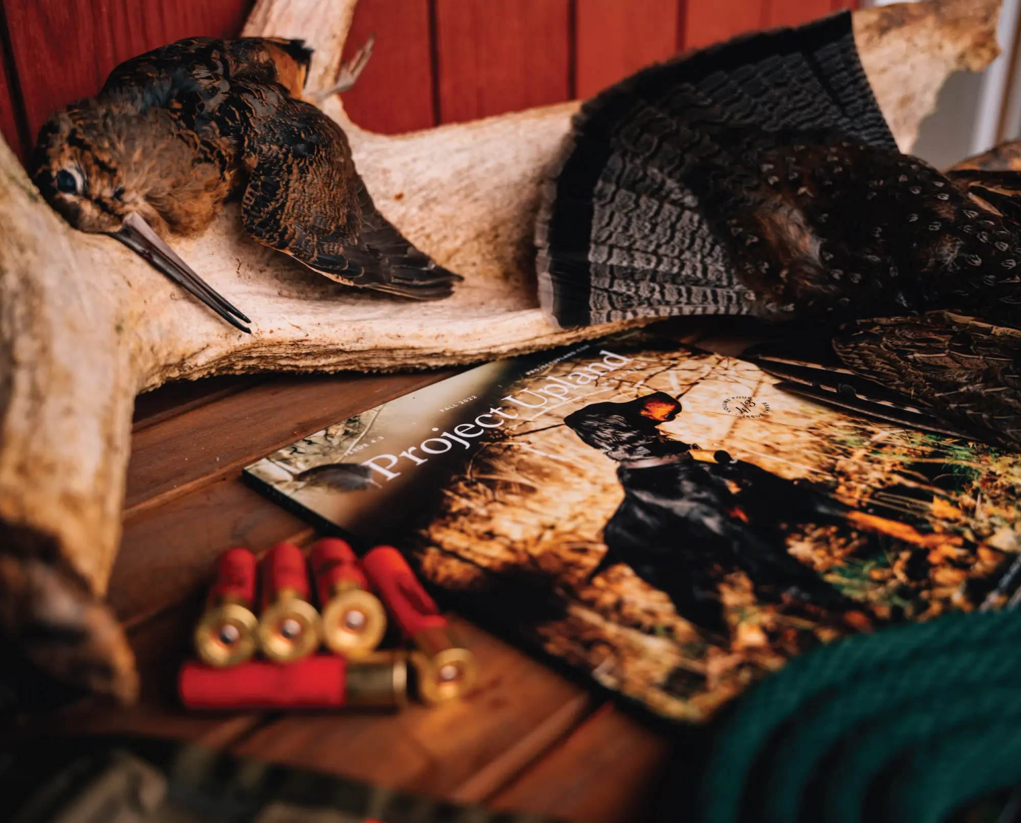 An issue of project upland magazine with some upland hunting gear and grouse