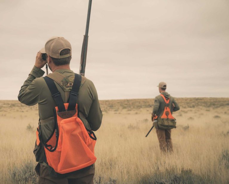 a bird hunter using binoculars