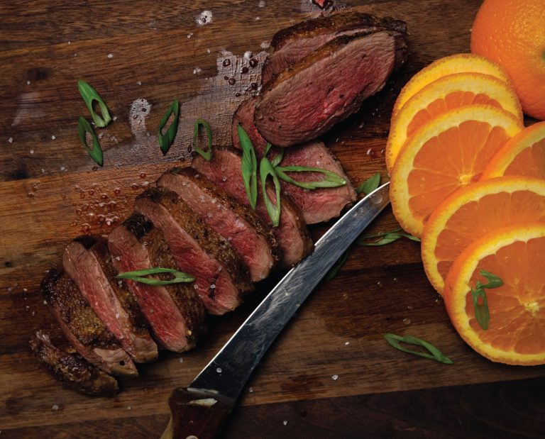 A perfectly cooked goose breast sliced and ready to serve