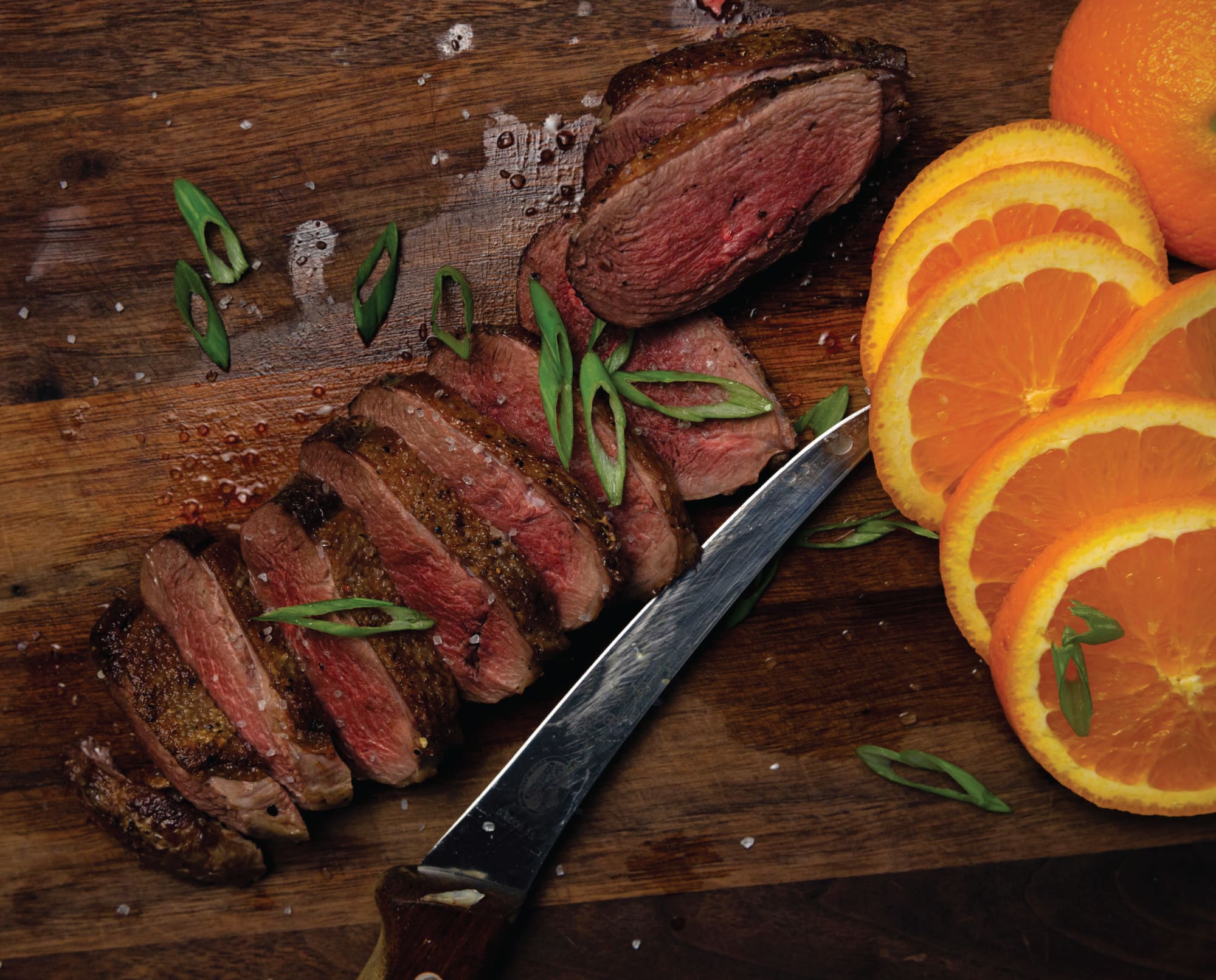 A perfectly cooked goose breast sliced and ready to serve