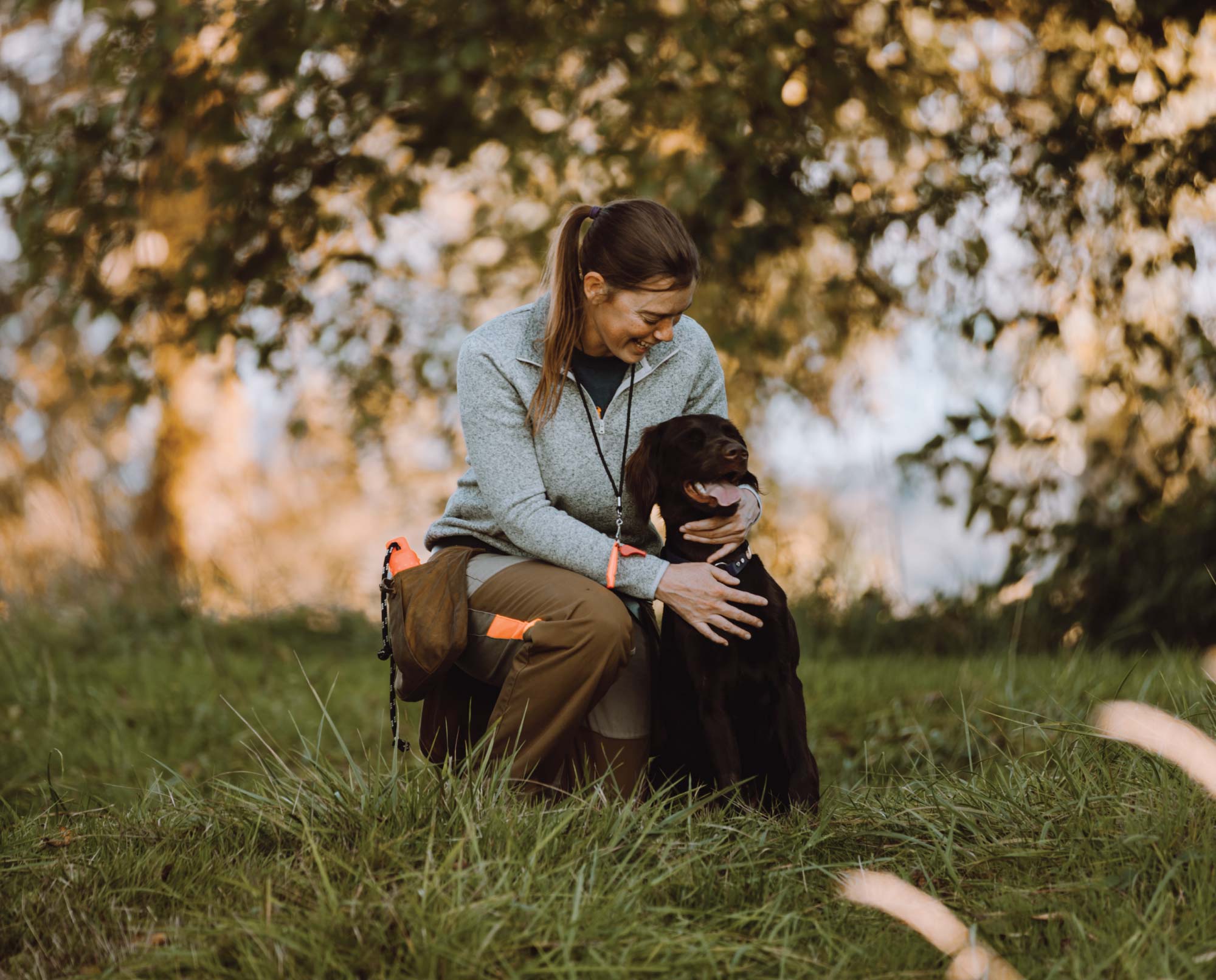 A bird hunter with her hunting dog