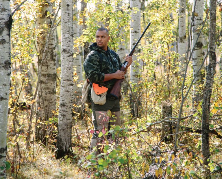 An African American hunter hunting birds.