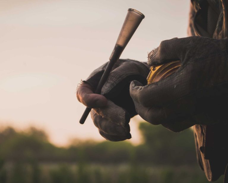 A veteran turkey hunter using a pot call to call in wild turkeys.