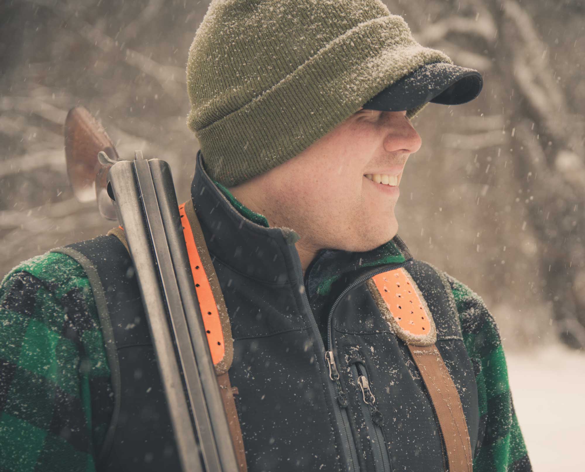 A bird hunter carrying a vintage L.C. Smith shotgun.