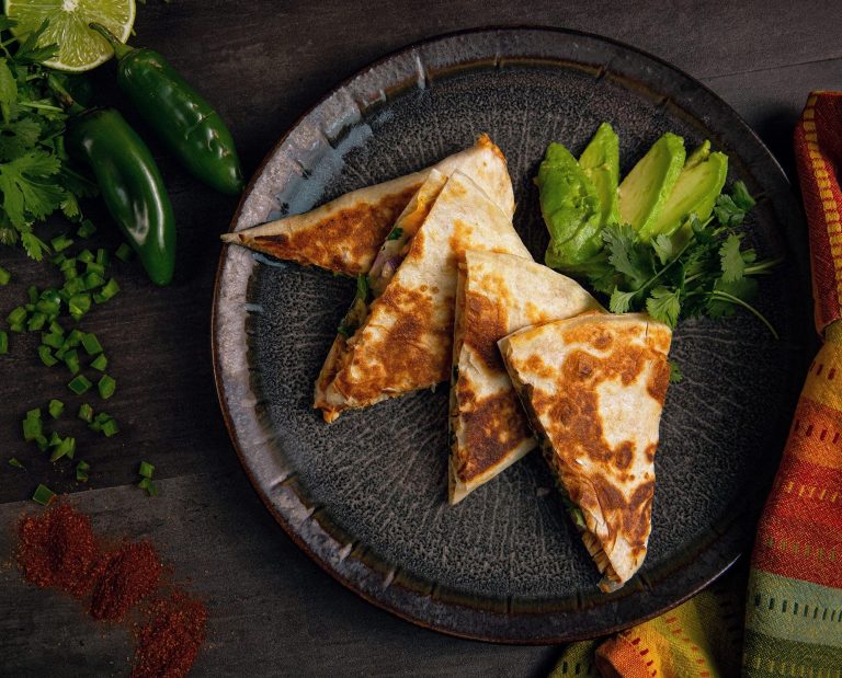 Quesadillas with quail meat rests on a plate.