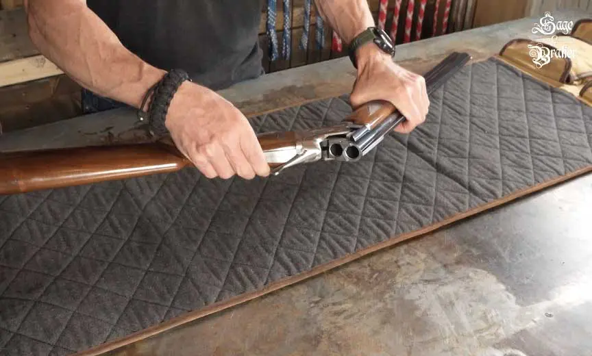 checking that over/under shotgun is unloaded