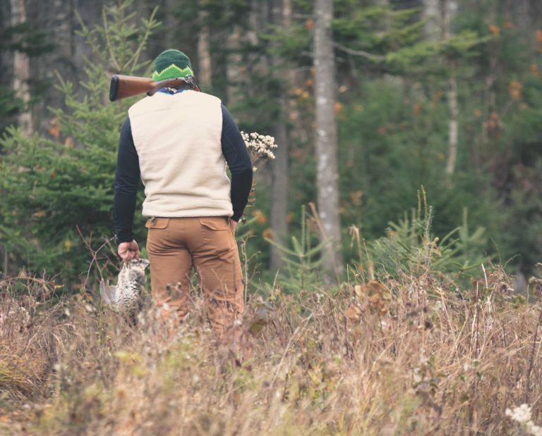 a partridge hunter holding a partridge in New Hampshire.