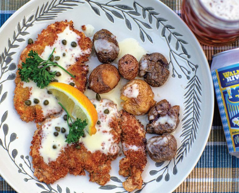Pheasant schnitzel with beurre blanc sauce on a floral plate