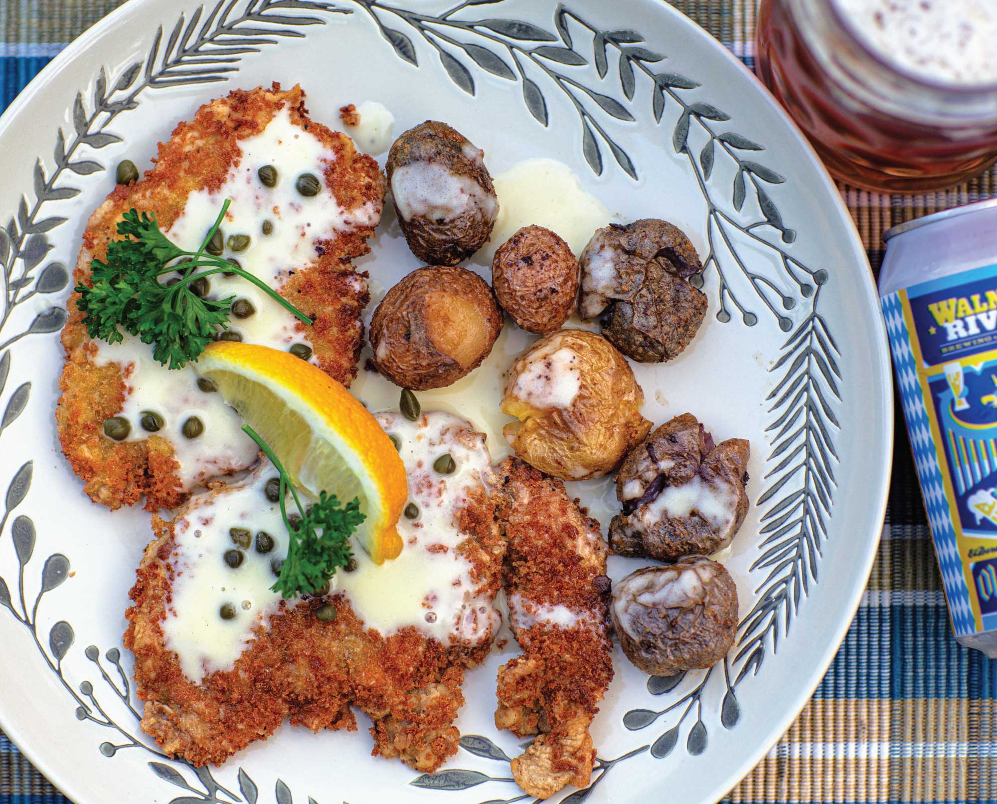 Pheasant schnitzel with beurre blanc sauce on a floral plate