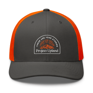 A blaze orange backed hat for bird hunting with the classic Project Upland logo.