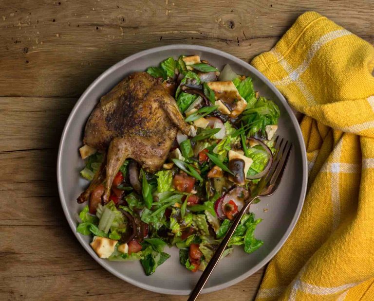 Roasted whole quail on a bed of lettuce for a Mediterranean inspired fattoush salad