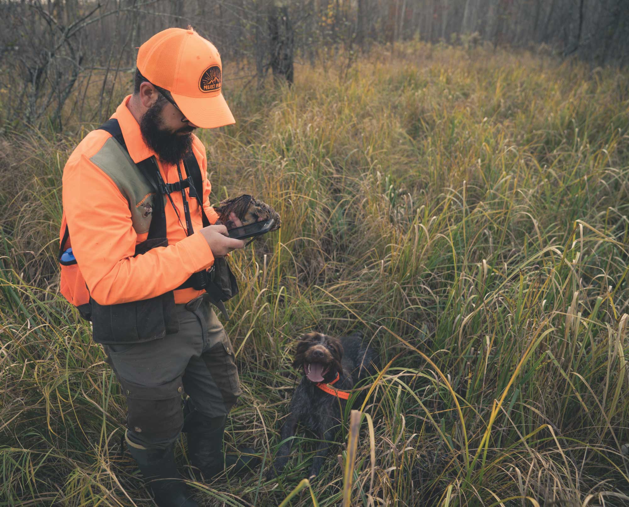 A bird hunter wearing an Orvis Waxed Cotton Strap Vest