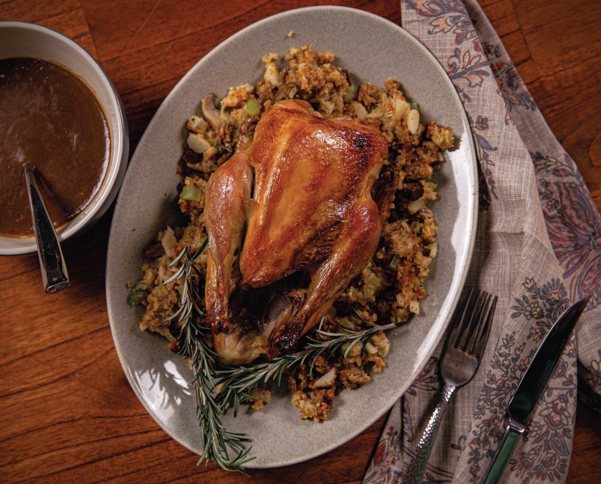 A roasted pheasant with cornbread stuffing and gravy ready to serve for dinner.