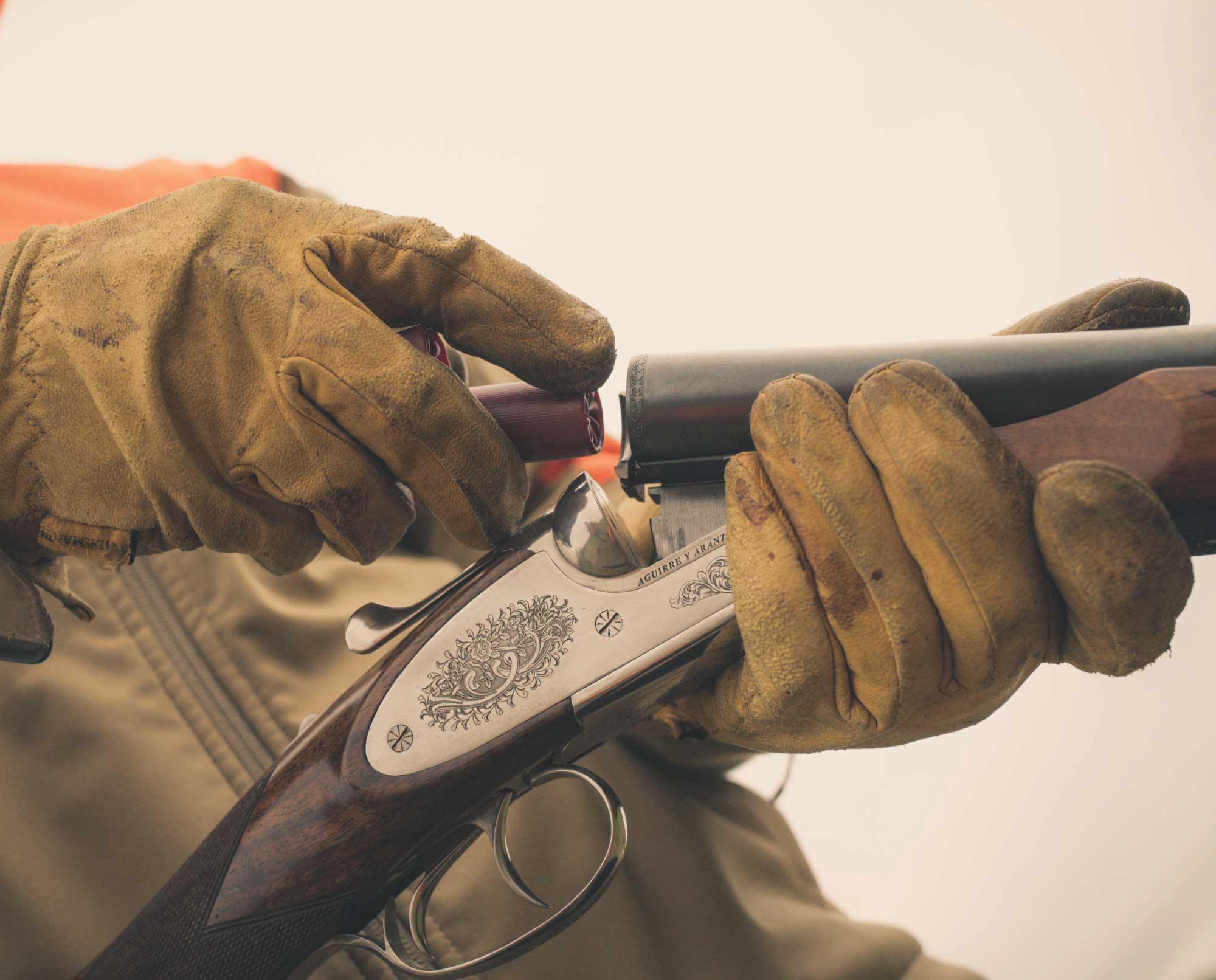 A bird hunter loads his shotgun with lead shot.