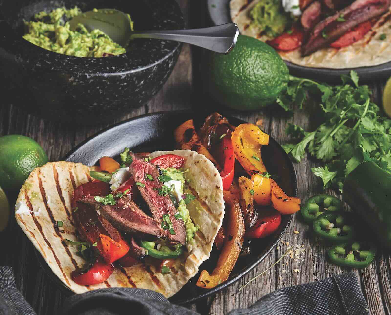 Seared sharp-tailed grouse meat served in fajitas on tortillas with peppers and cilantro