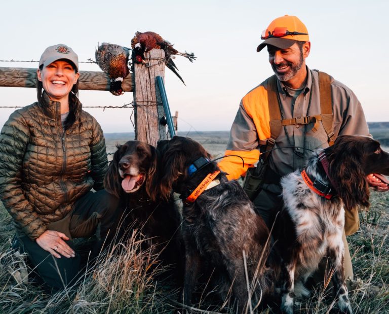 Two hunters with bird dogs in South Dakota on a hunting trip
