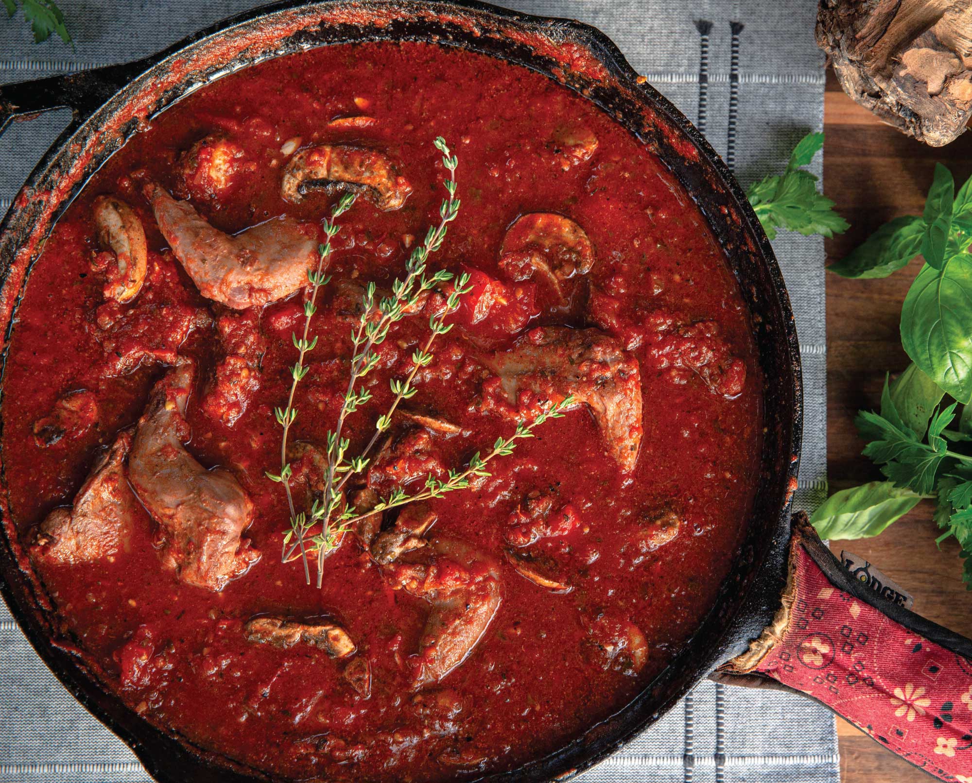 A cast iron skillet of squirrel cacciatore
