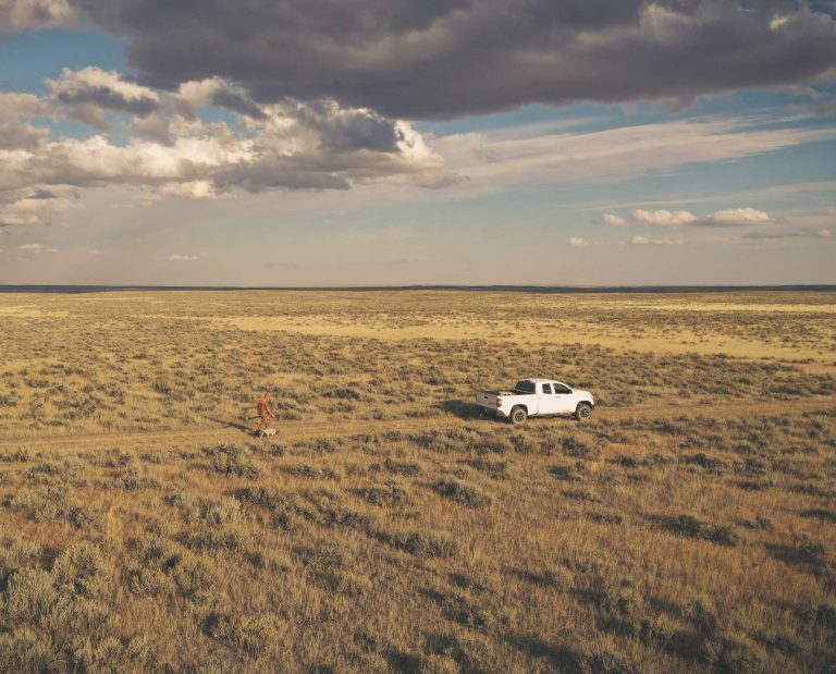 A grouse hunter walking to his truck on public lands.