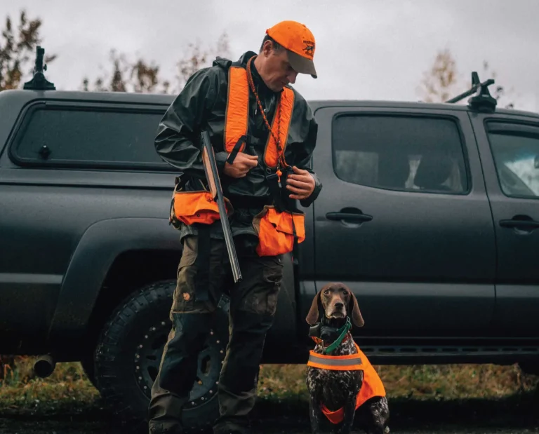 Dog trainer Jason Carter commands his dog in the field