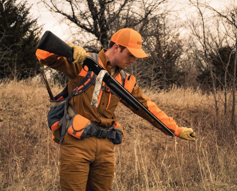 A bird hunter uses a bore snake to clean his shotgun