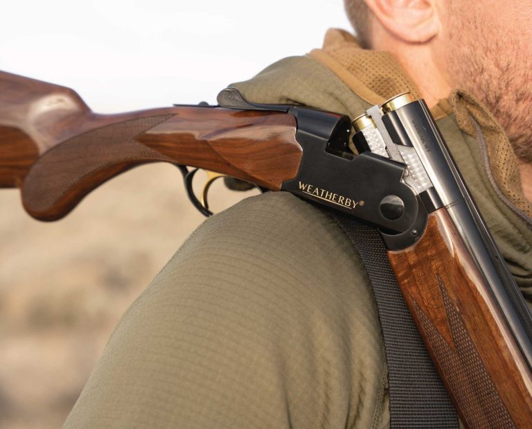 A hunter carries a Weatherby Orion 20 gauge while bird hunting