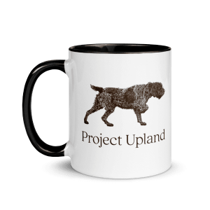 A coffee mug with a classic Wirehaired Pointing Griffon design on it.