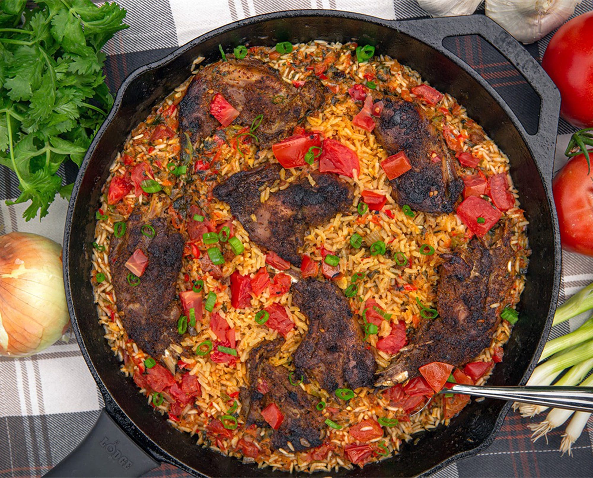 Arroz con prairie grouse rests in a cast iron skillet.