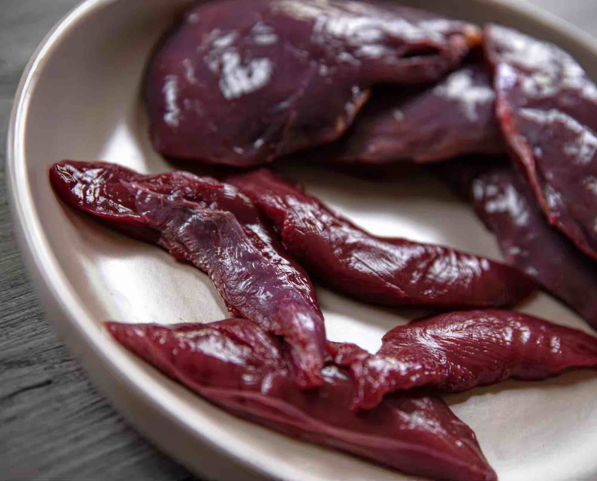 Raw upland bird tenderloins on a plate