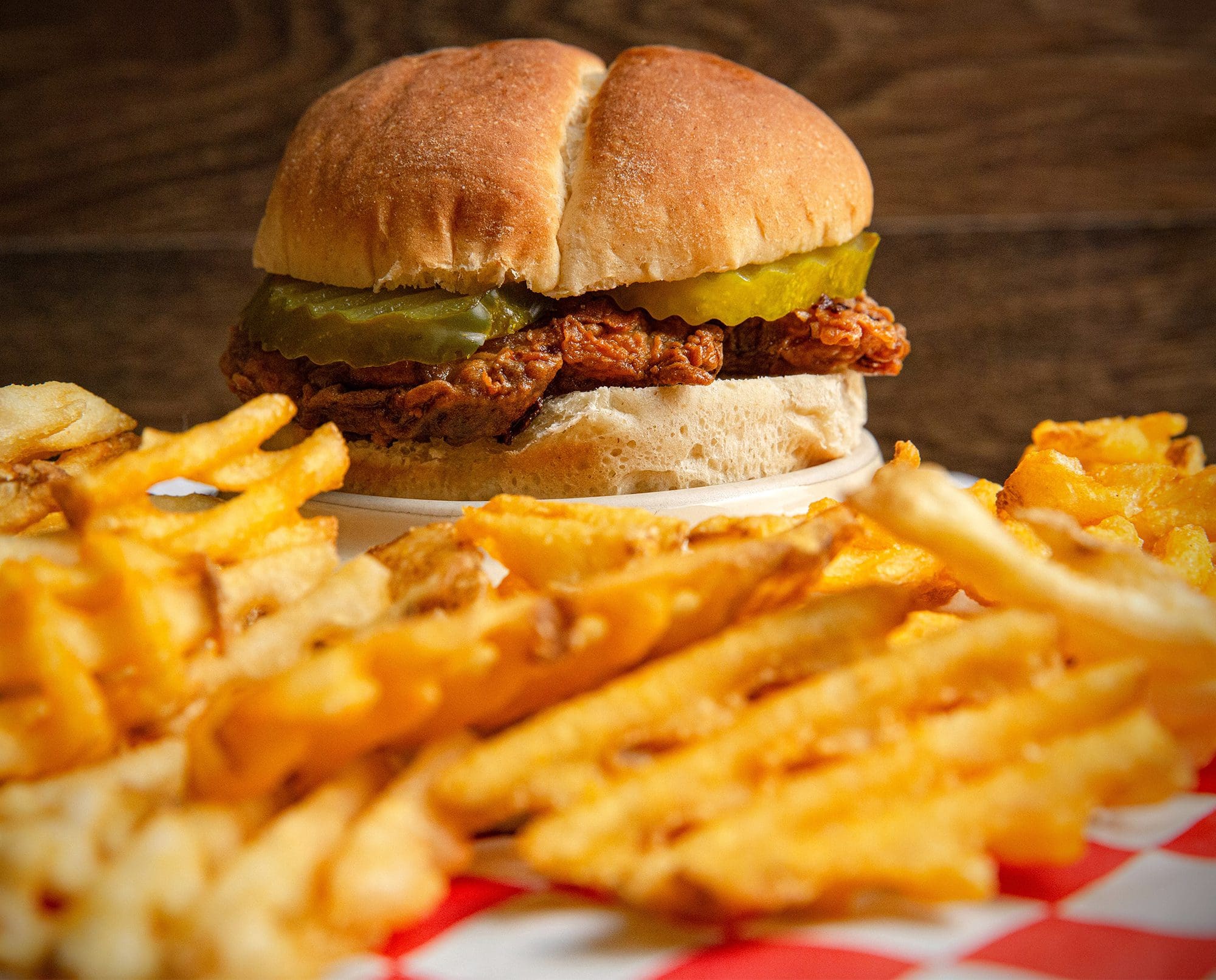 A chukar sandwich and fries rest on a table.