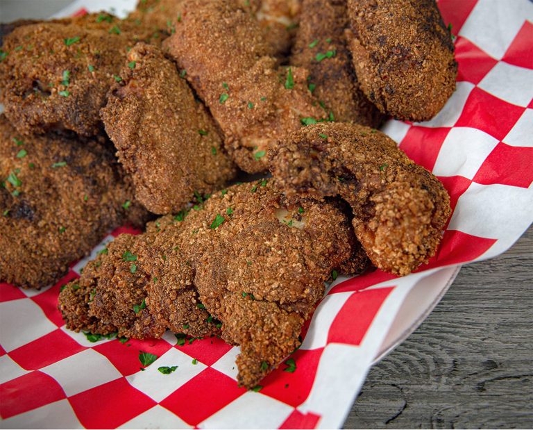 Fried pheasant rests on serving paper.