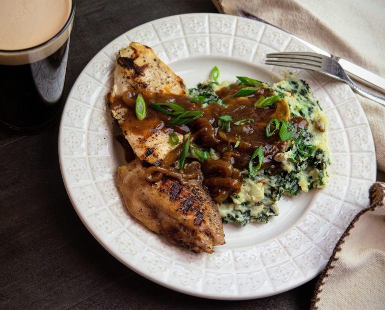 Grilled pheasant and colcannon rests on a plate.