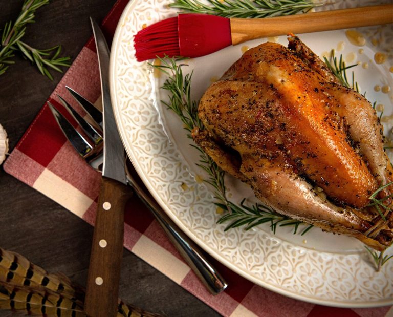 Roasted pheasant sits on a table.