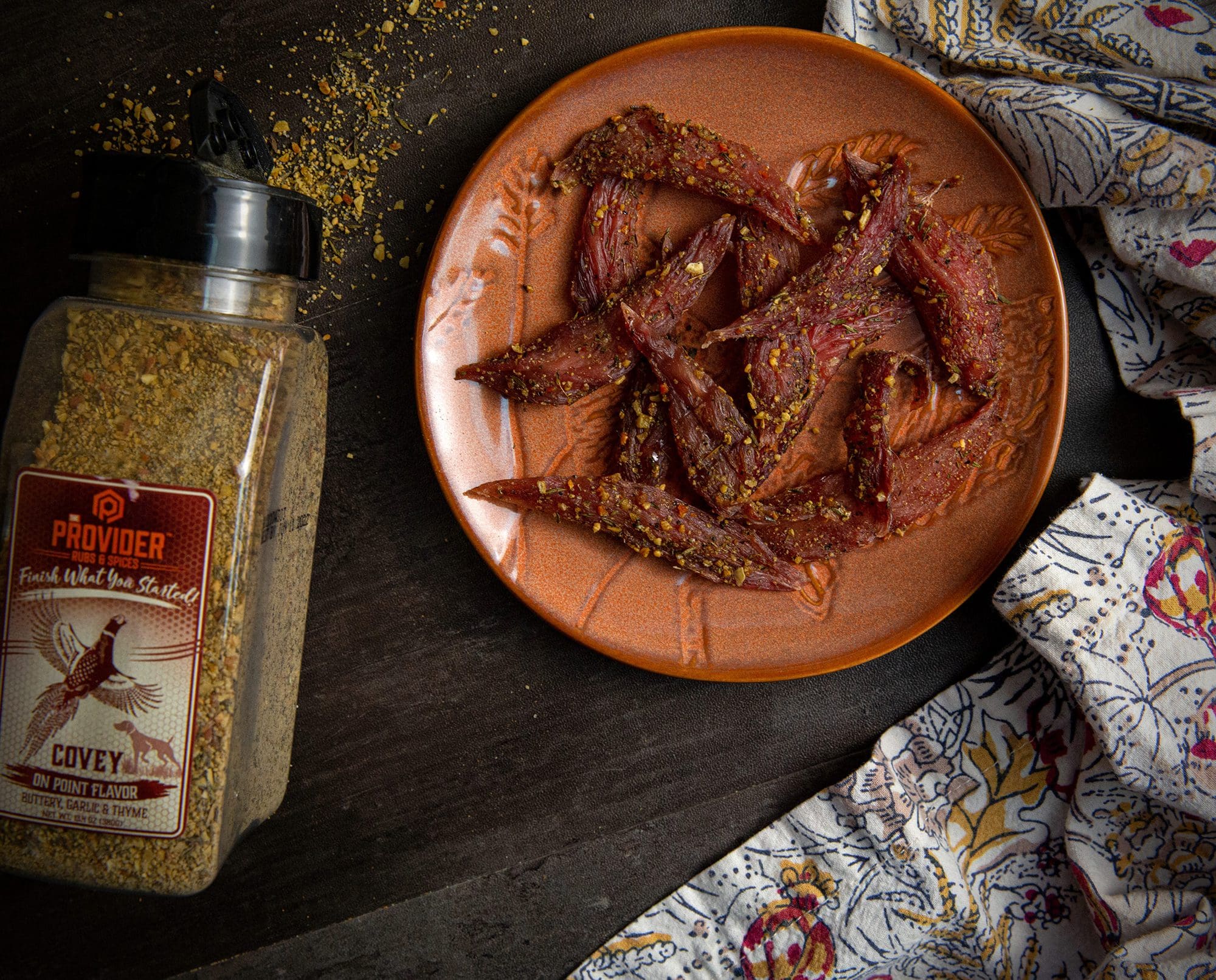 Upland bird 'kipper snacks' made from tenderloins rest on a table.